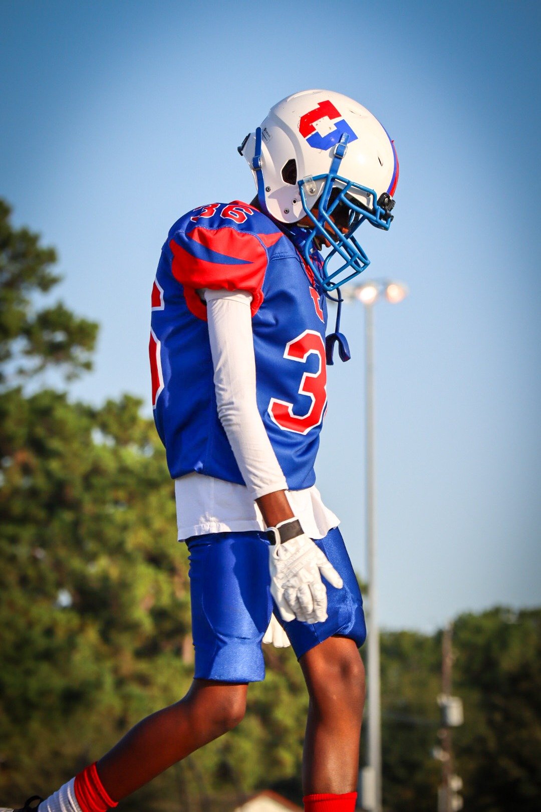 Student football player walking onto the field