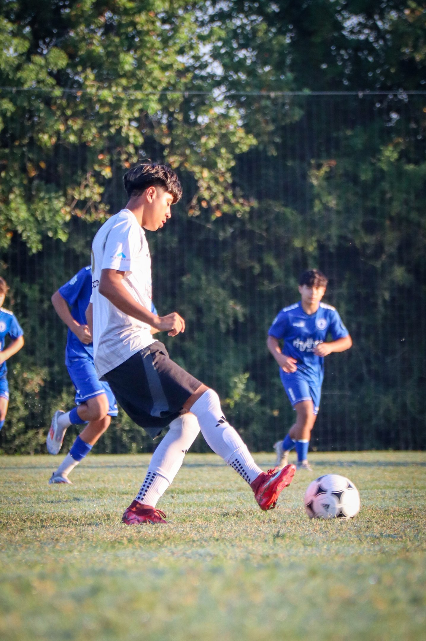 Student soccer player taking a shot
