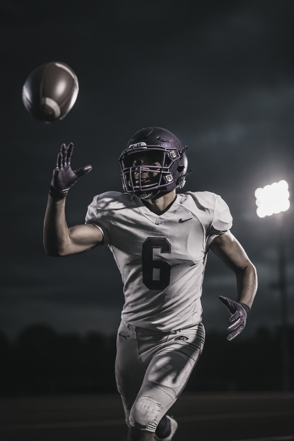 Football athlete under stadium lights